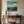 Load image into Gallery viewer, Ethereal series #07 artwork with teal sky and golden tree highlights displayed above a vintage wooden console table in a rustic room
